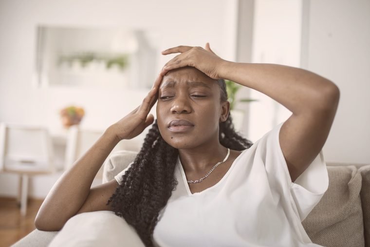 Woman pressing her forehead